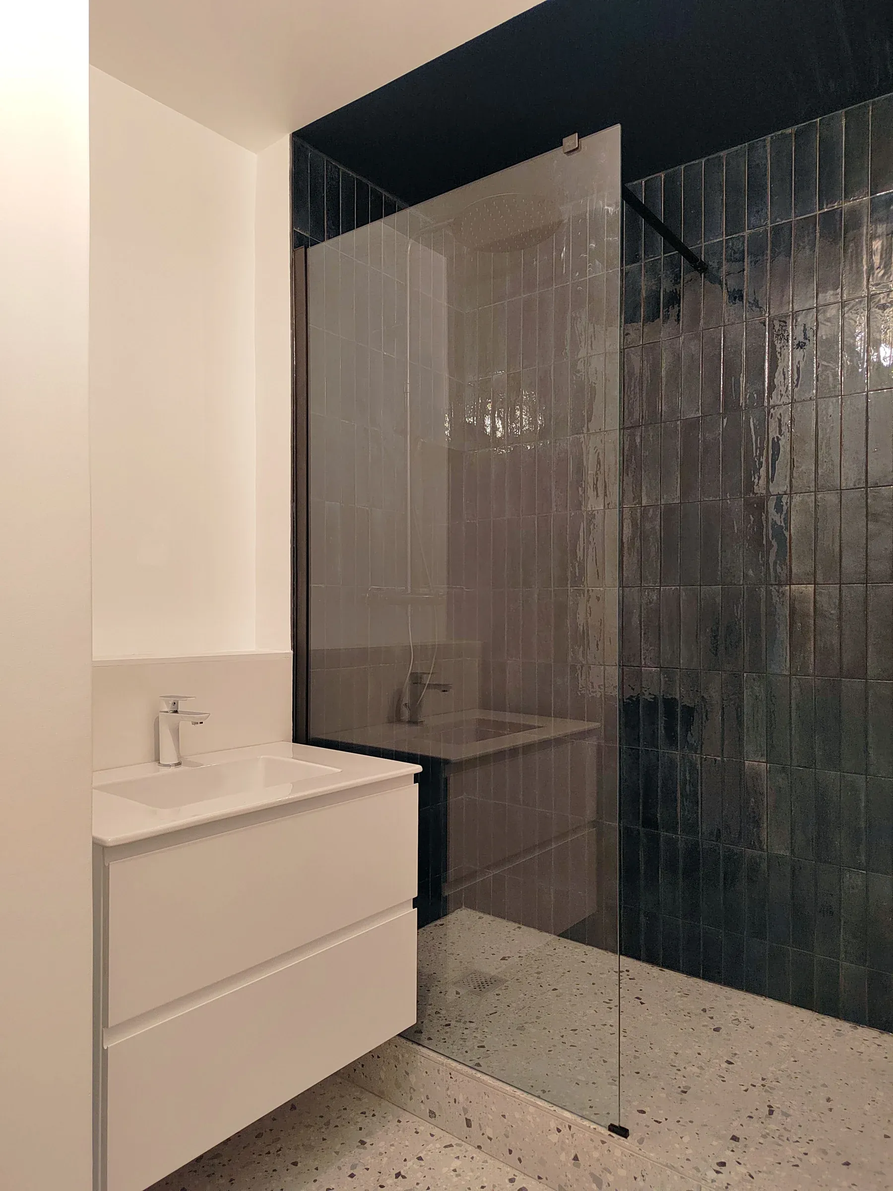 salle de bain blanche et carrelage effet zellige bleu nuit et sol terrazzo